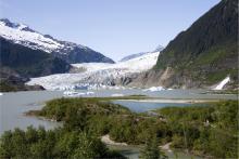 Photo of a mountain glacier flow into a lake